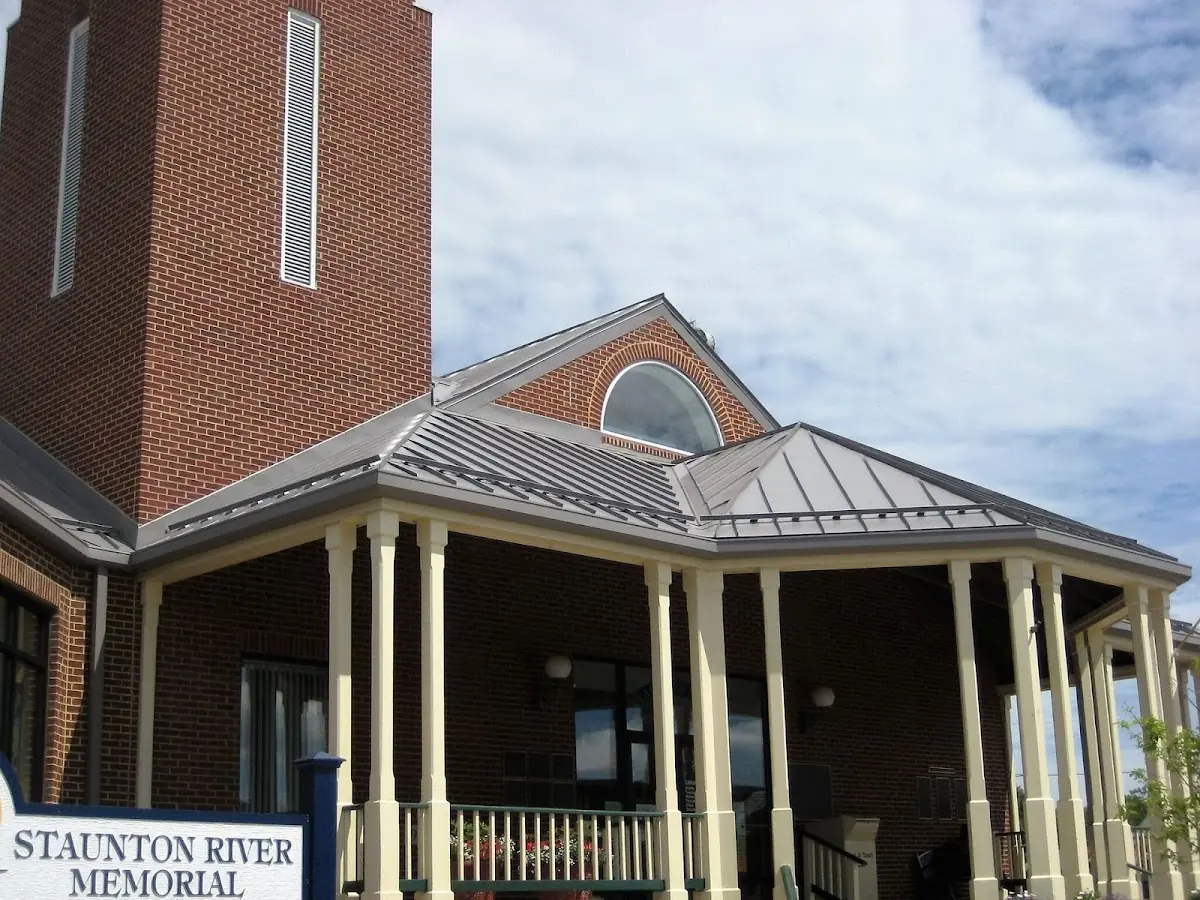 Skilled roofing craftsmen working on a residential roof in Central College